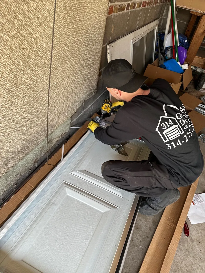 314 Garage Door technician installing garage door panel St. Louis MO